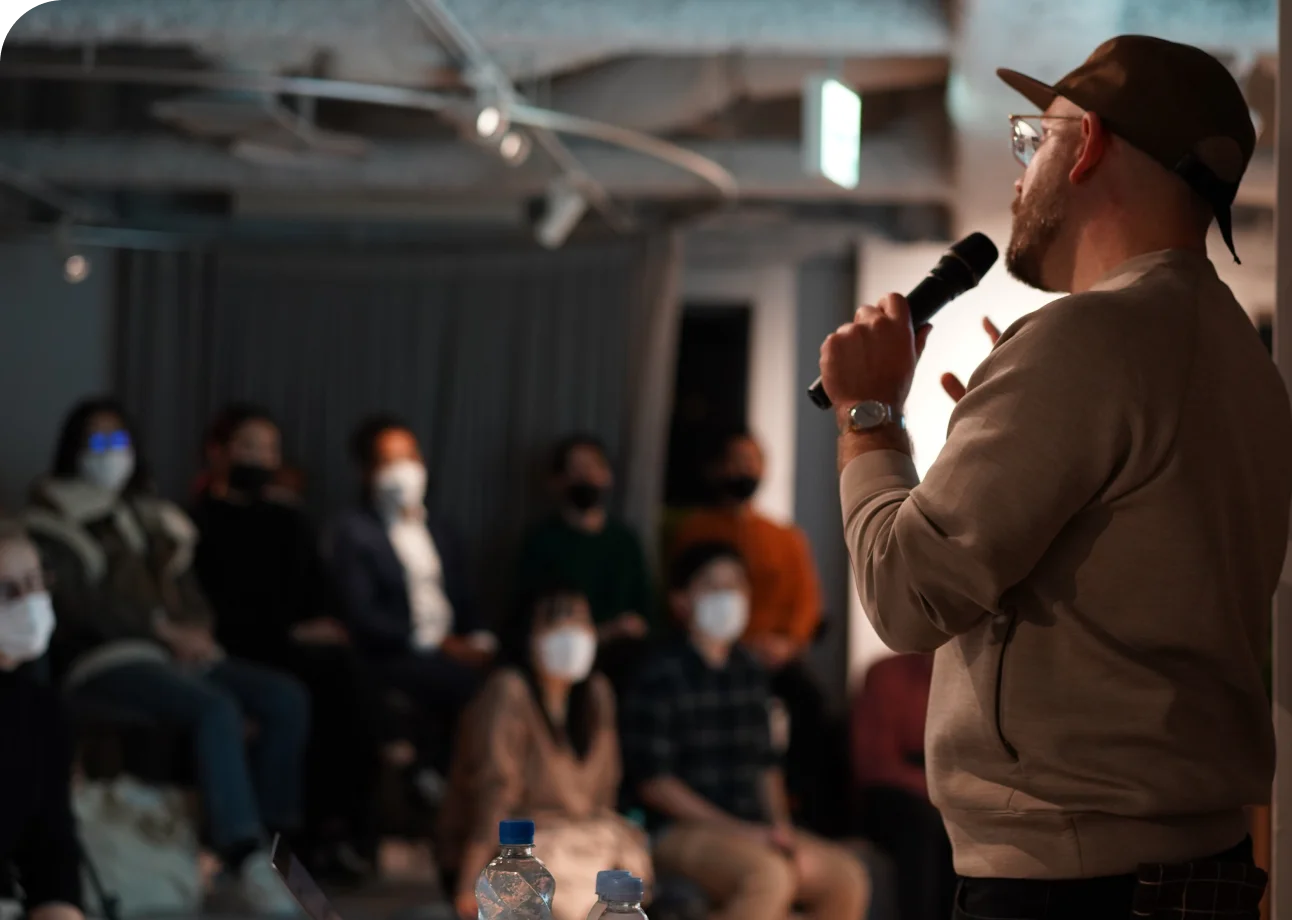 Speaker in front of a crowd at a Creative Tokyo event